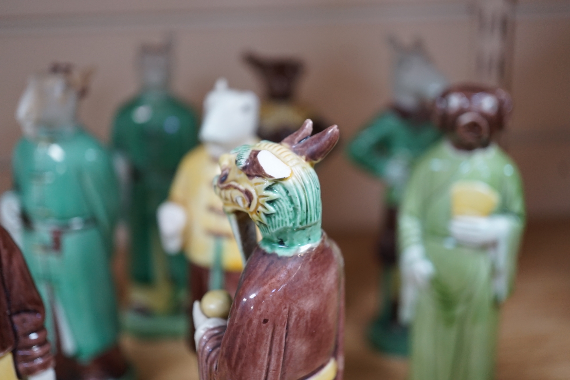 Ten Chinese Sancai glazed biscuit animal headed figures, tallest 17cm